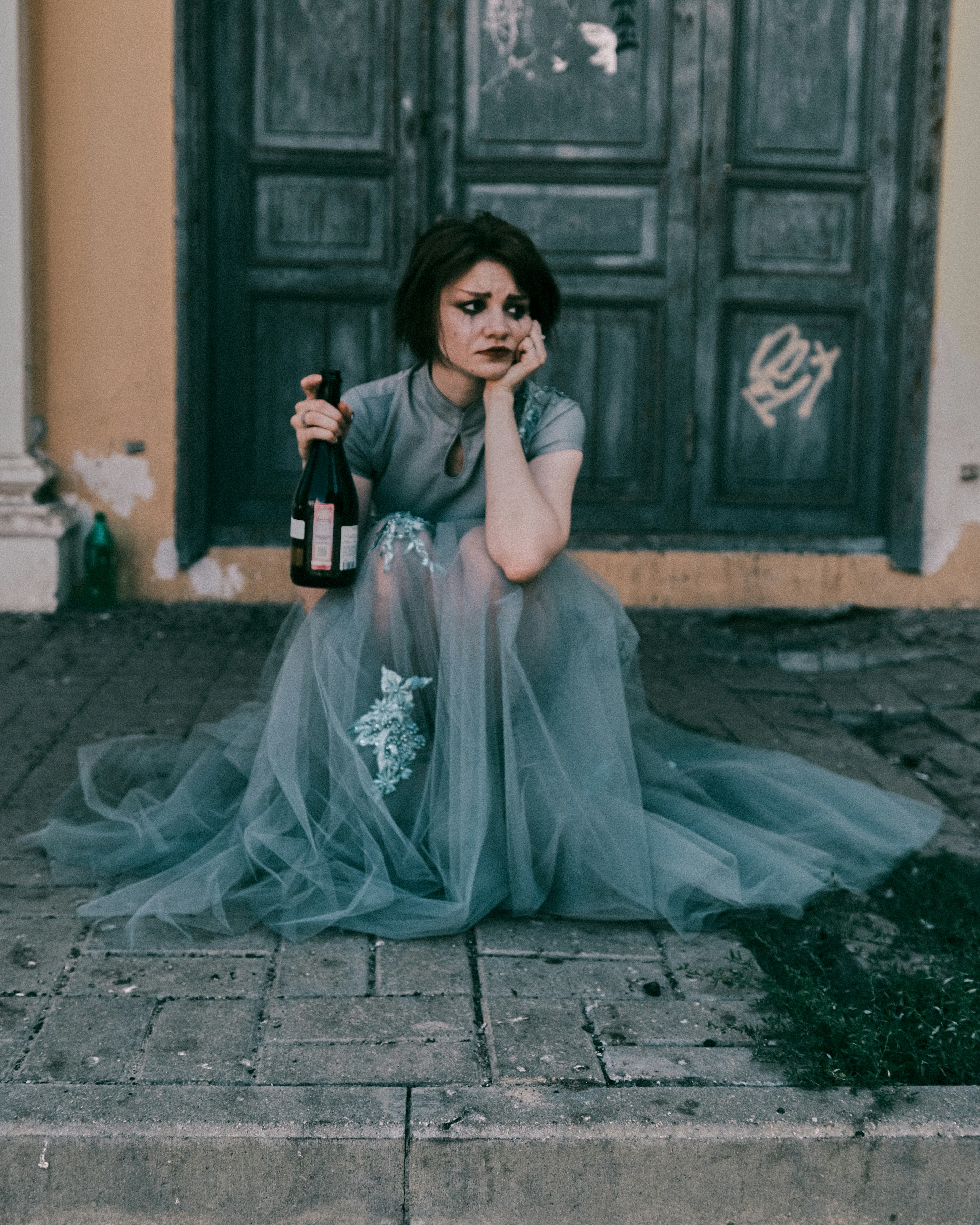 woman in white dress sitting on concrete floor